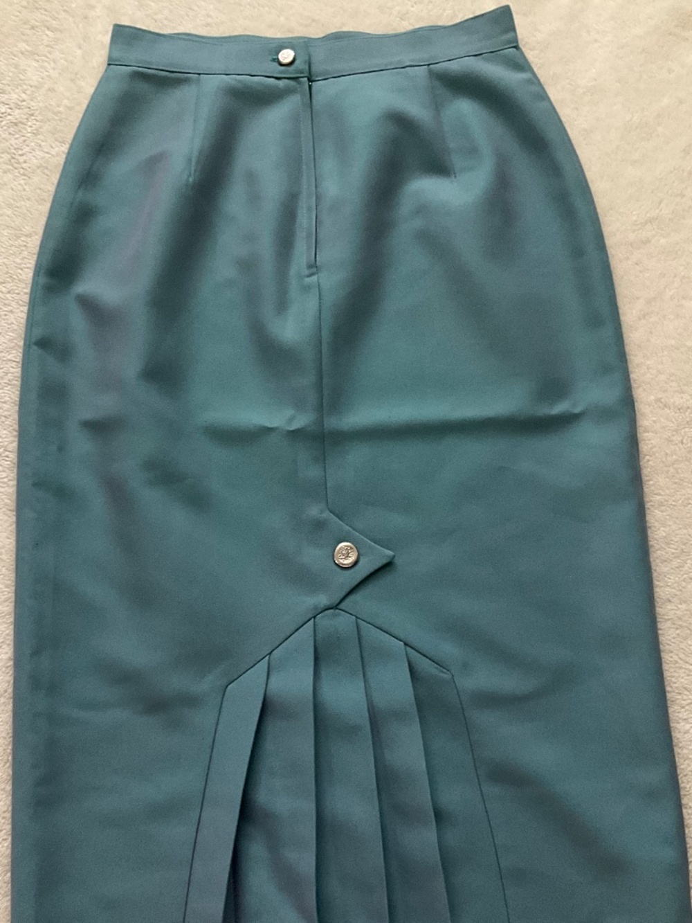 Vintage teal midi pencil skirt with a centre pleated hem and button detail